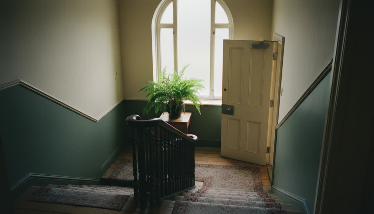 A stairwell with a fire door in a shared house
